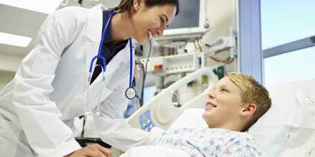 Doctor talking with patient in hospital bed