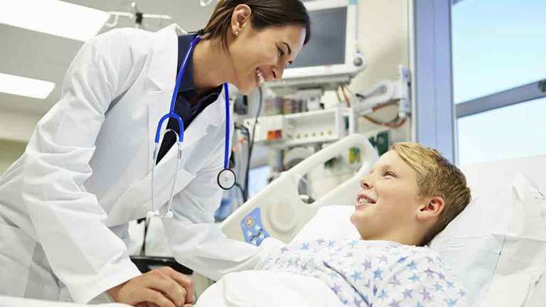 Doctor talking with patient in hospital bed