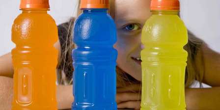 girl looking through bottles of sports drink
