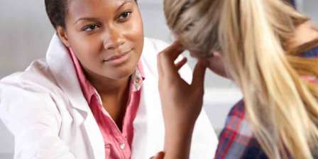 doctor in white coat counsels distressed woman