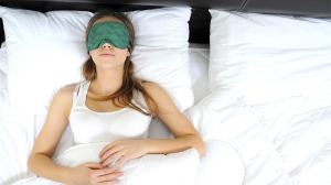 woman sleeps with blindfod over her eyes