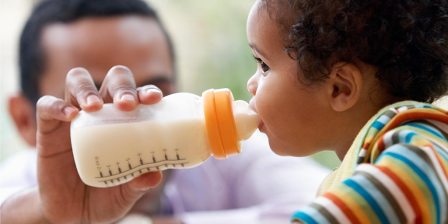 toddler drinking from a bottle
