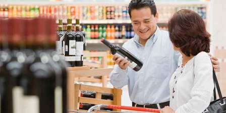 man at bottleshop checkout