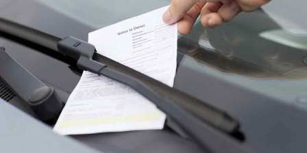 person lifts fine off car