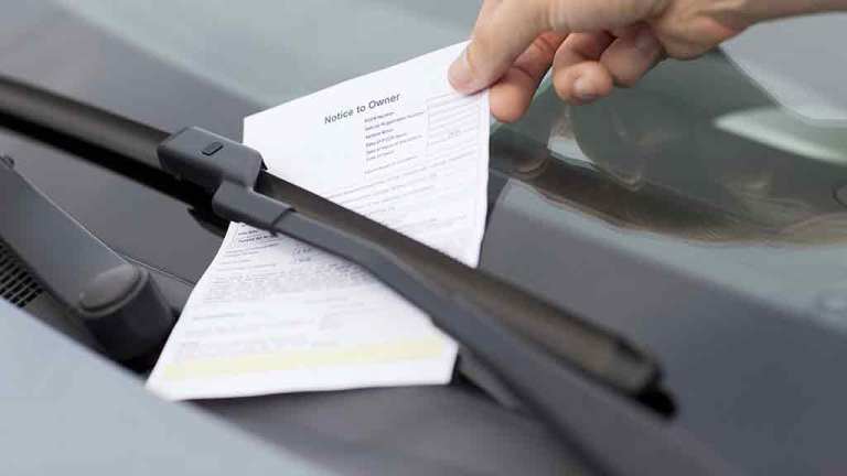person lifts fine off car