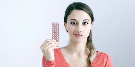 woman holding pill packet