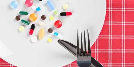 pills on a plate with knife and fork