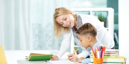 boy studying with teacher