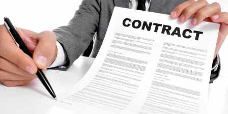 man holding pen and contract