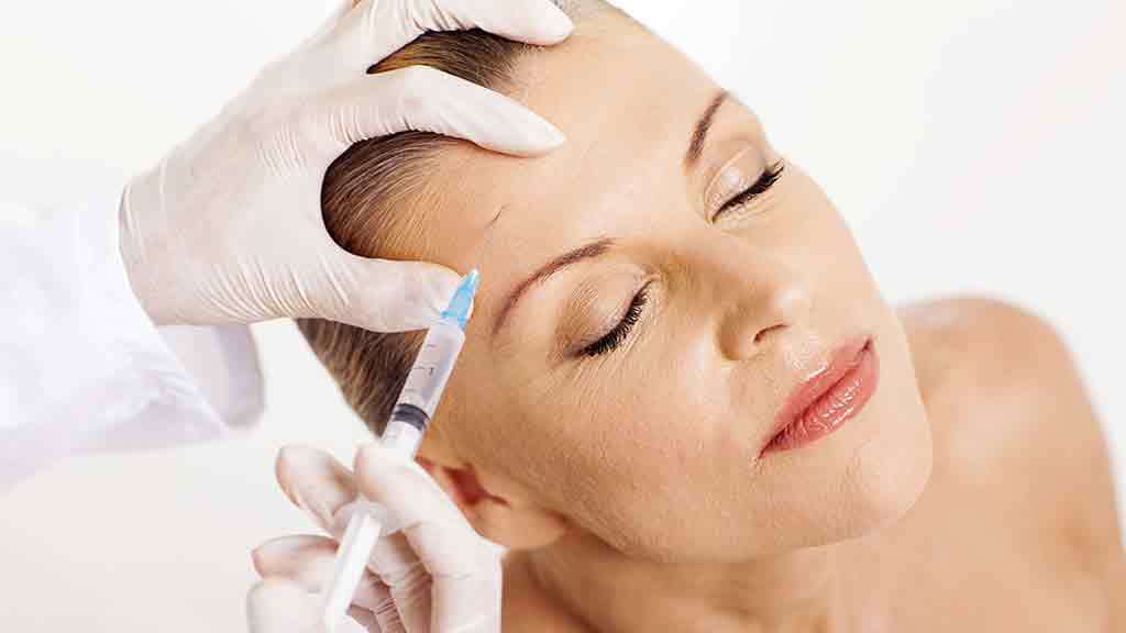 woman receiving cosmetic injection in face