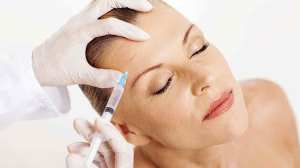 woman receiving cosmetic injection in face