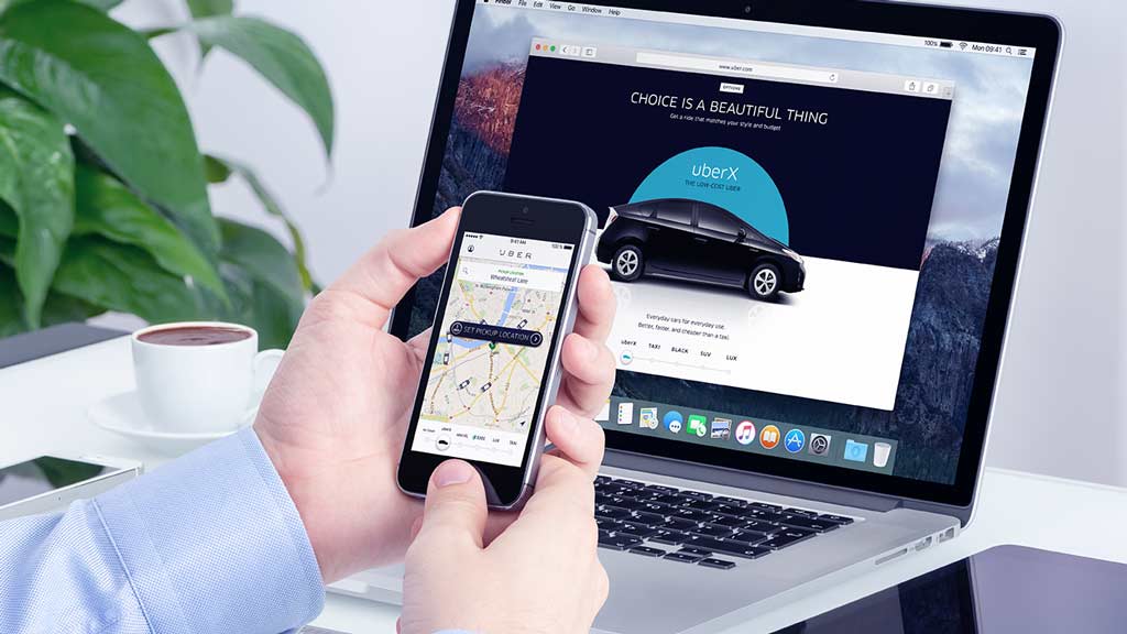 man booking an uber on mobile lead