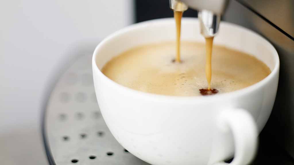 expresso puring from coffee machine