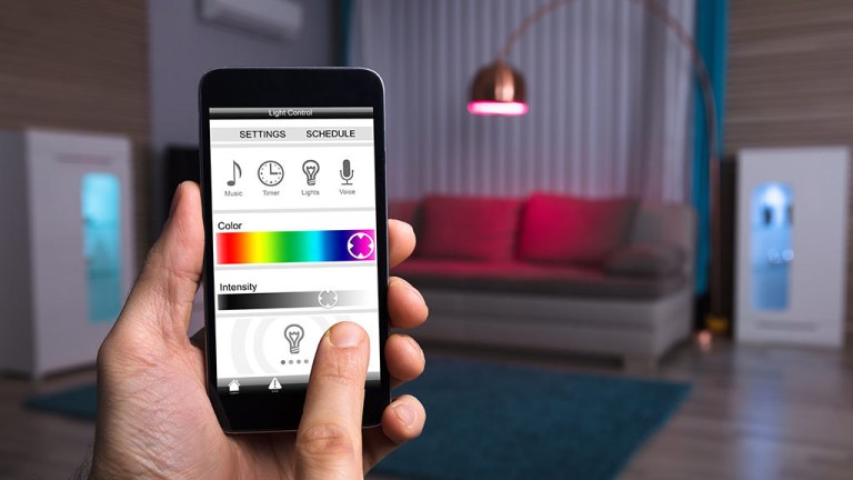 person_using_smart_light_control_with_phone