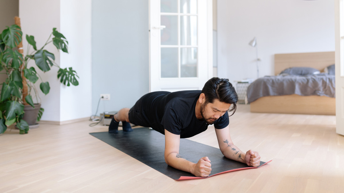 man doing at home workout lead