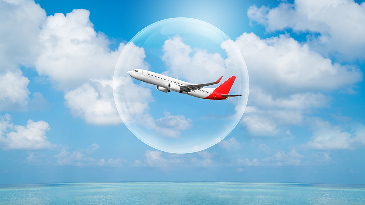 Airplane flying over water while in a clear bubble.
