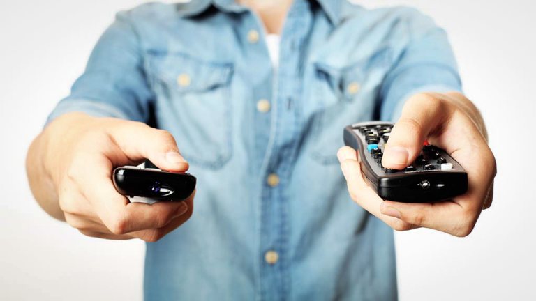 man pointing remotes at screen tv reliability