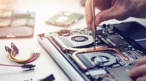 person repairing a laptop
