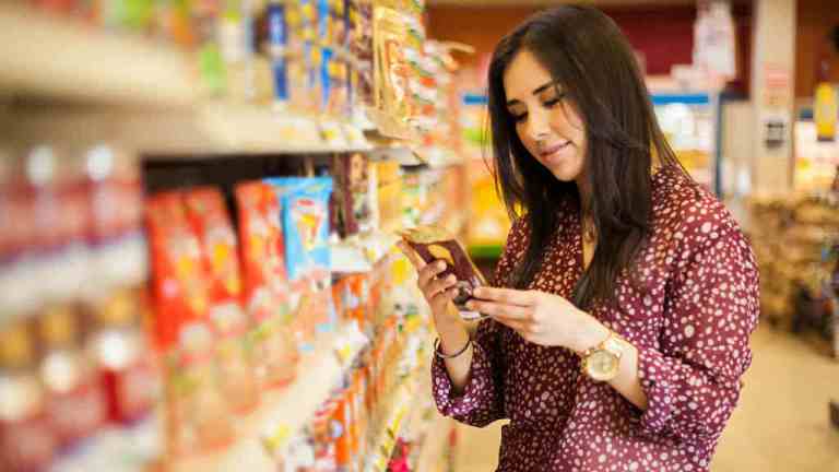 woman reading product label
