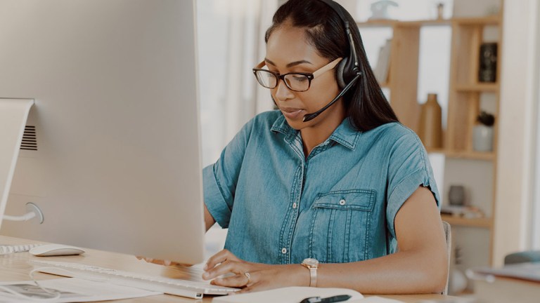 woman_working_from_home_wearing_bluetooth_headset