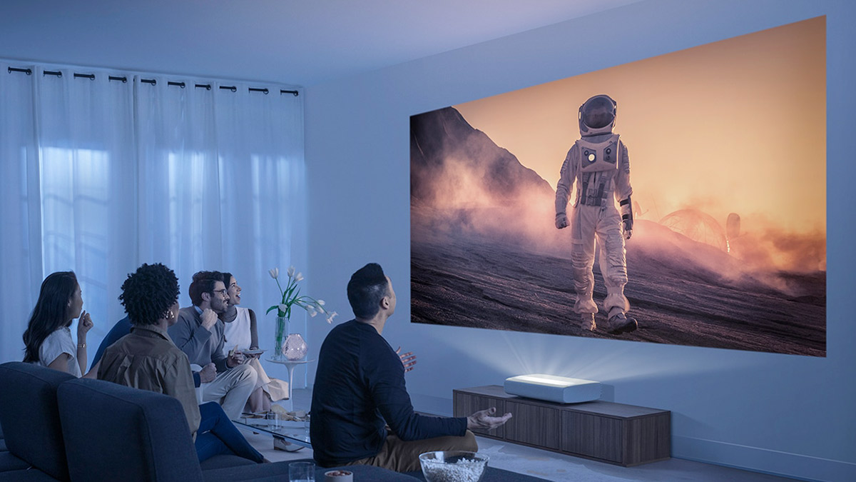 friends watching a movie on a projector at home
