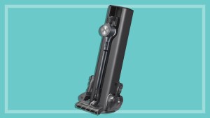LG CordZero A9T-Ultra stick vacuum on a teal background