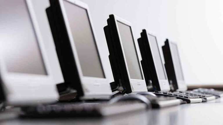 row of desktop computer screens