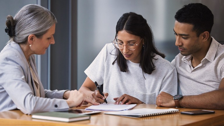 young_couple_signing_financial_document