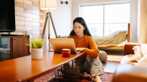 young_woman_looking_at_super_expenses_on_laptop