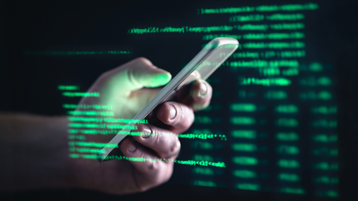person's hand holding a mobile phone with a green data code overlay
