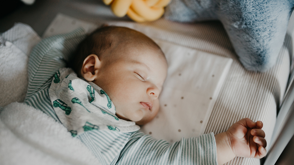 baby_in_cot_full_of_pillows_blankets_and_other_products