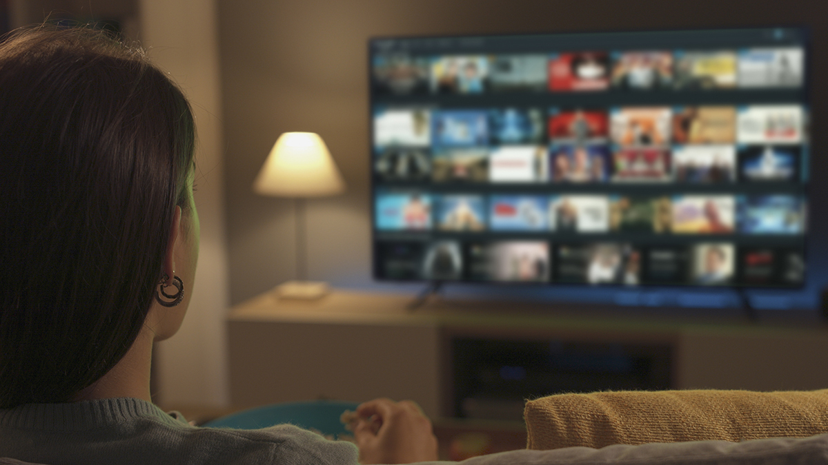 person_selecting_a_program_on_smart_tv