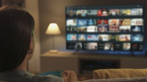 person_selecting_a_program_on_smart_tv