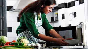 person cooking in a microwave oven