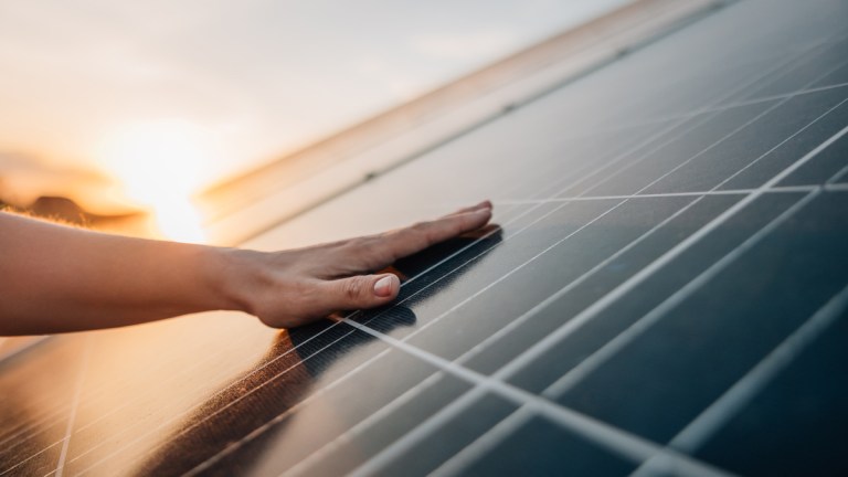 hand_on_solar_panels
