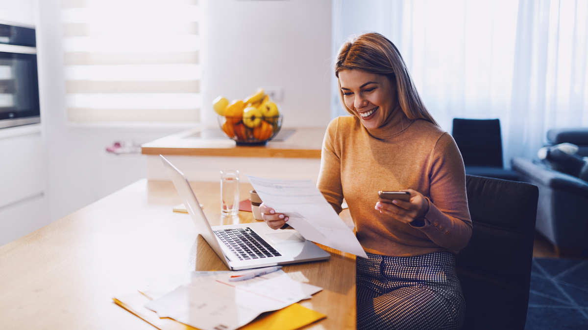 woman_looking_at_paperwork_and_phone