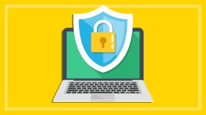 antivirus sofware shield and padlock on laptop on a yellow background
