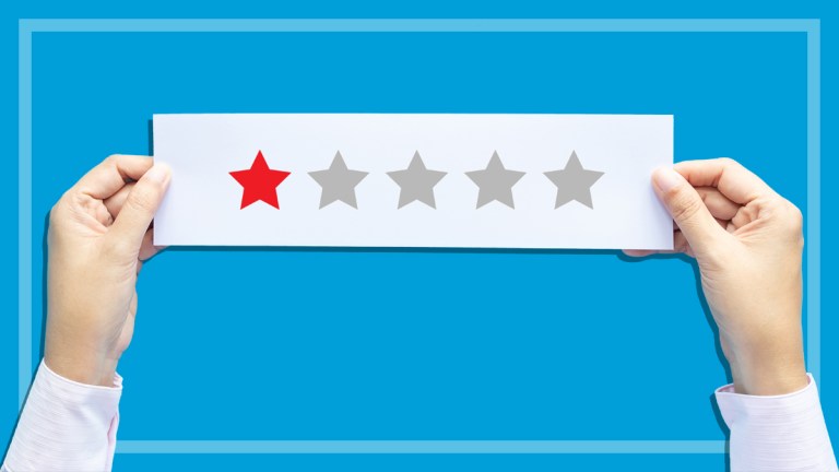 hands_holding_piece_of_paper_with_one_star_rating