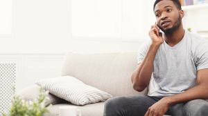 man taking a call on his mobile at home
