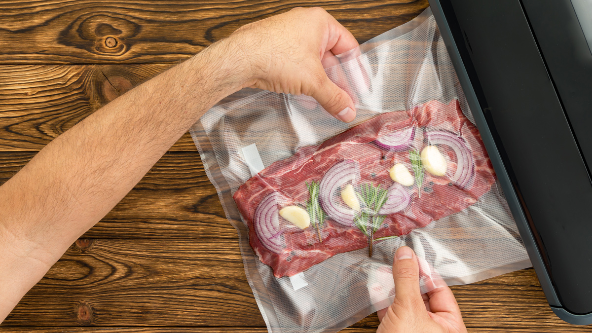 using a vacuum sealer to seal meat and herbs