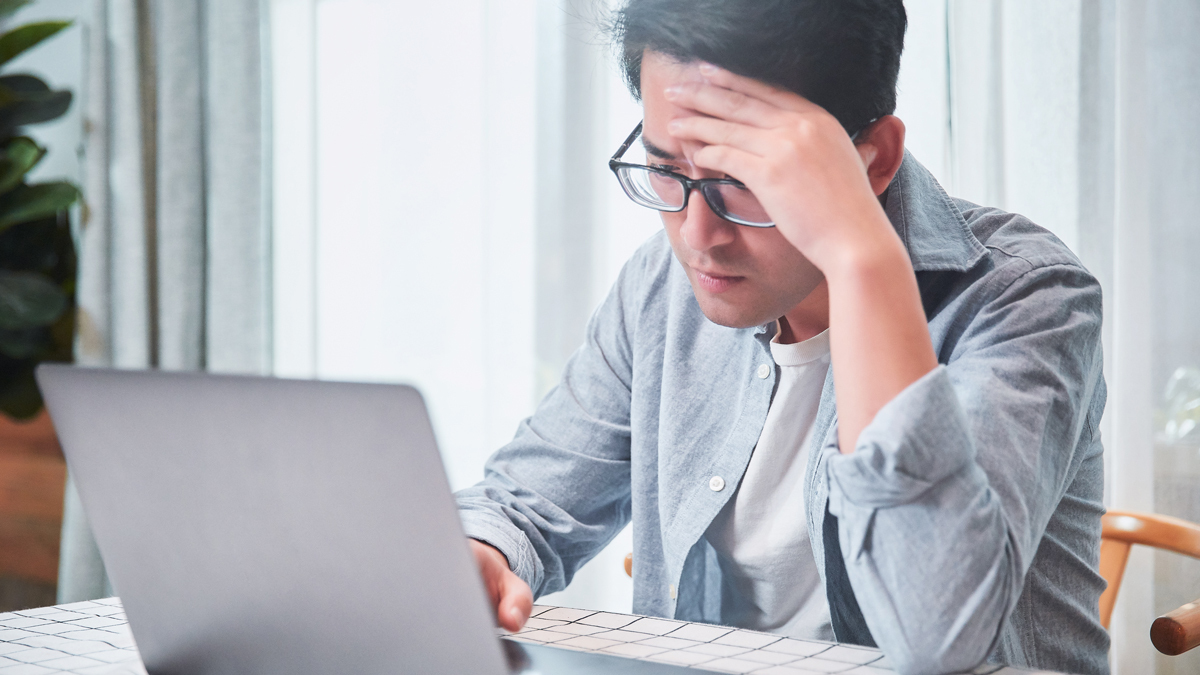 person looking concerned at laptop