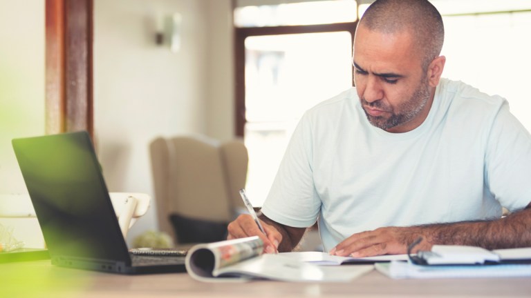 Indigenous man writing complaint