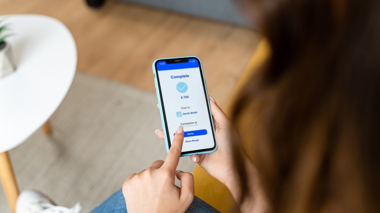 person transferring money using smartphone