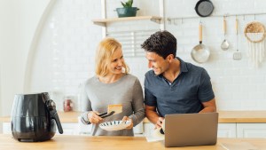 man_and_woman_cooking_with_air_fryer