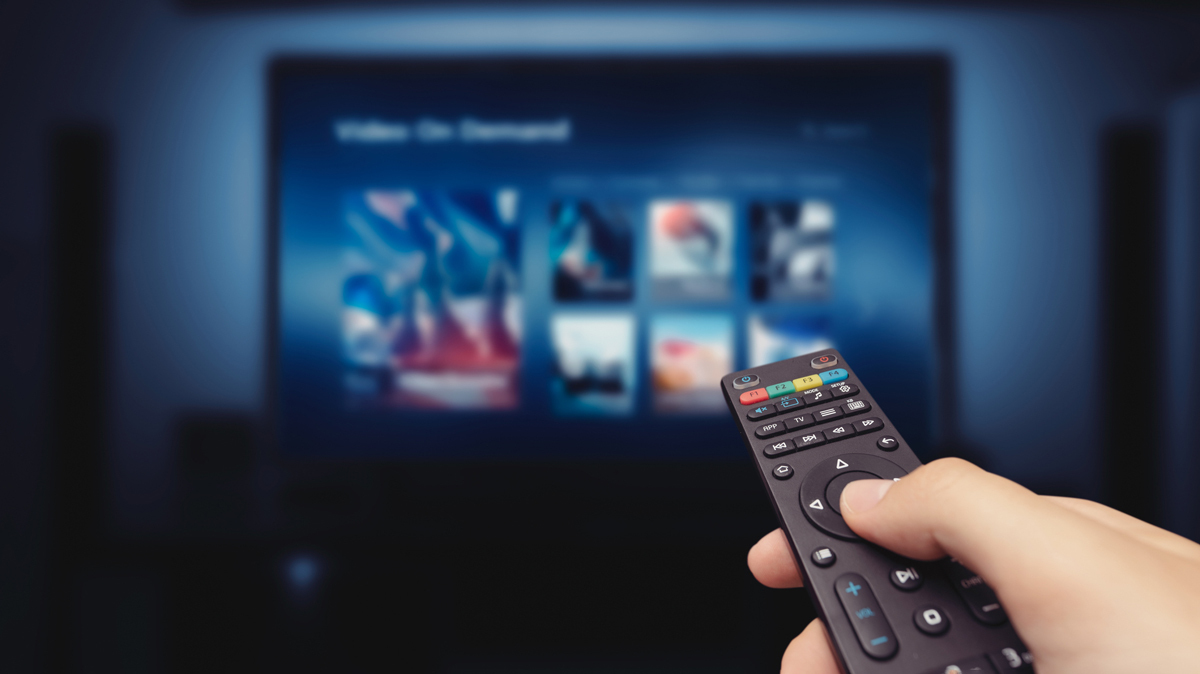 person using a TV remote