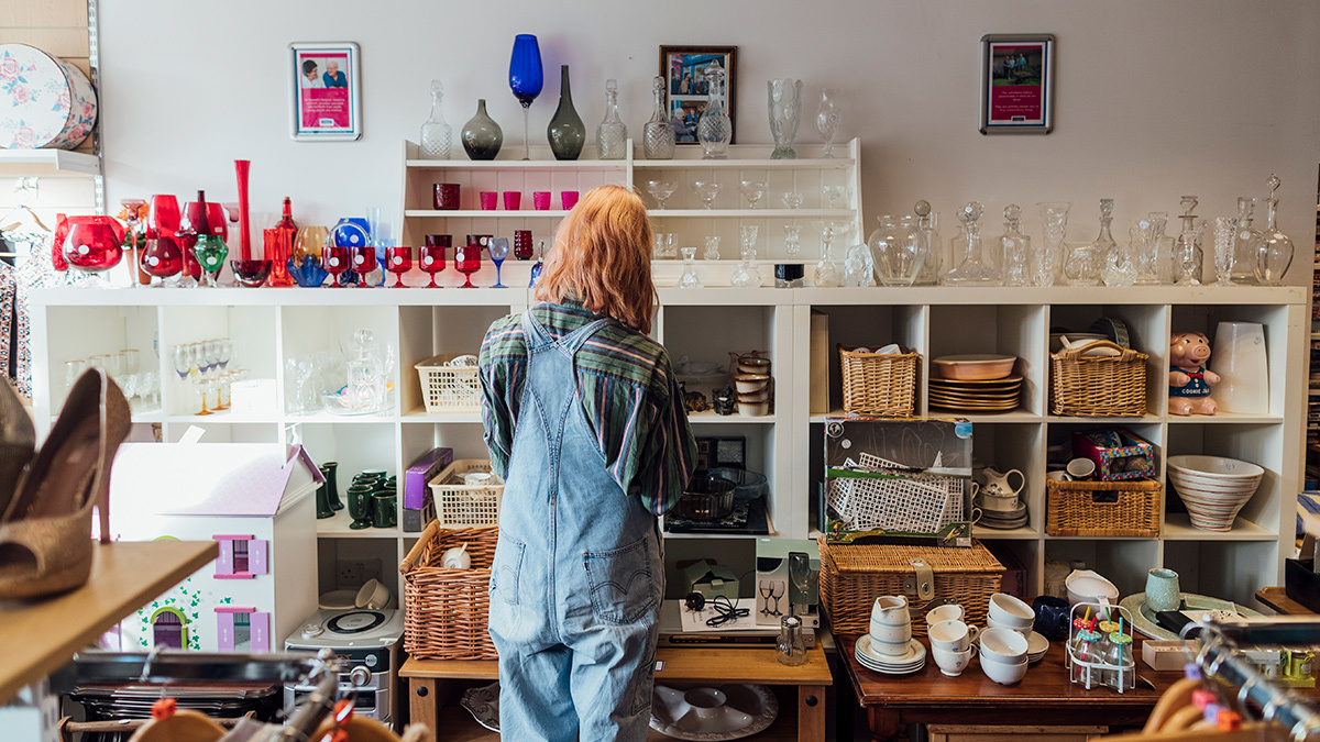 person looking for secondhand kitchenware in an op shop
