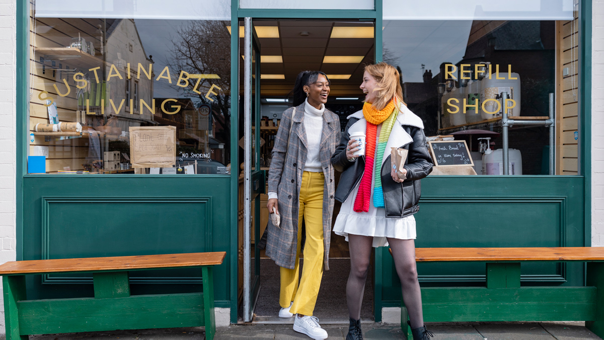 two women walking out of a sustainable refillable store