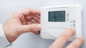 hands adjusting ducted air conditioner controls