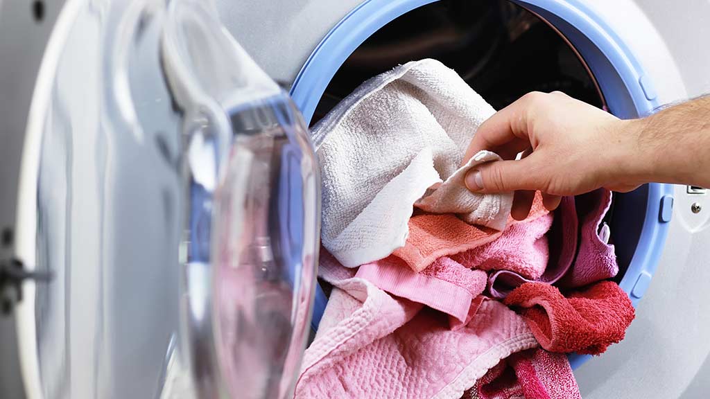 pulling dry laundry out of dryer