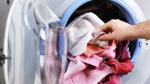 pulling dry laundry out of dryer
